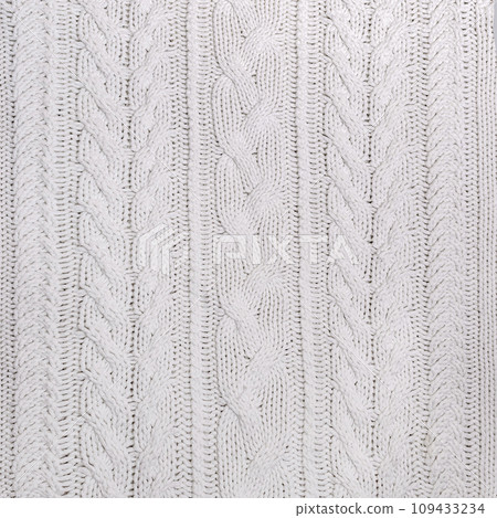 The texture of a white knitted sweater in close-up The texture of a white knitted sweater in close-up 109433234