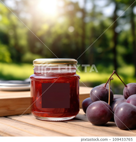 jar of plum jam with blank front realistic on a mockup template in a wooden table in a summer garden with plum trees, 109433765