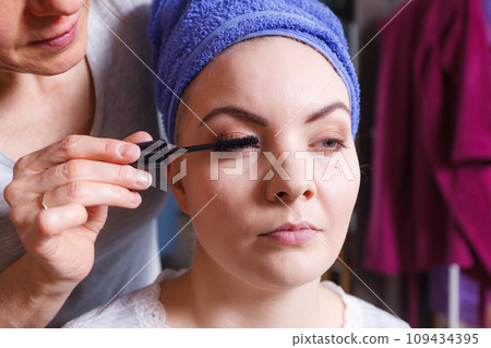 Woman getting her make up done by expert Woman getting her make up done by expert 109434395