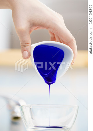 Woman pouring purple hair dye or shampoo Woman pouring purple hair dye or shampoo 109434862