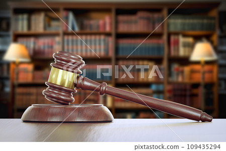 Gavel Resting on a Table Inside a Law Office with Bookshelf of Law Books in the Background. 109435294