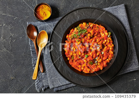 chakalaka, spicy tomato bean relish in black bowl 109435379