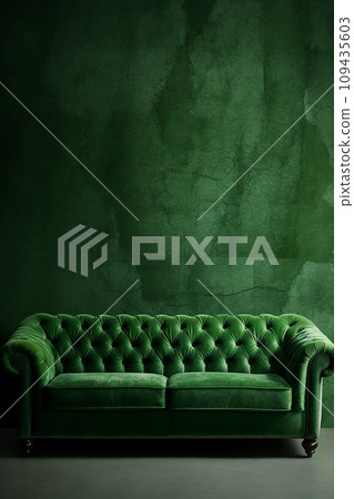 Elegant luxury green velvet sofa in a waiting room against a textured green wall 109435603