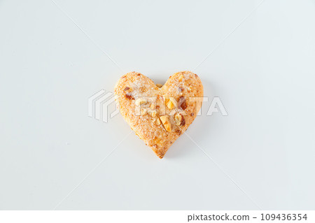 One heart shaped cookie on a white background One heart shaped cookie on a white background 109436354