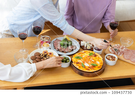 A woman eating food on a table A woman eating food on a table 109437730