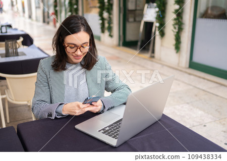 Freelance woman sitting in cafe working with Freelance woman sitting in cafe working with 109438334