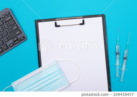 Vaccination or Revaccination Concept - Two Medical Syringe on Blue Table Vaccination or Revaccination Concept - Two Medical Syringe on Blue Table 109438457