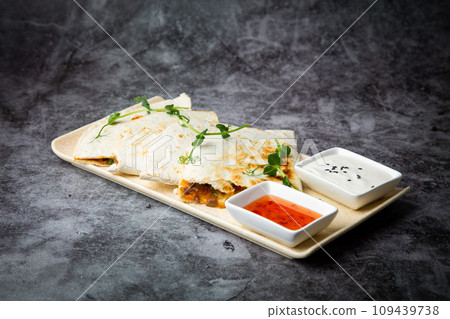 crispy flatbreads stuffed with meat, herbs, lime and two sauces, side view crispy flatbreads stuffed with meat, herbs, lime and two sauces, side view 109439738