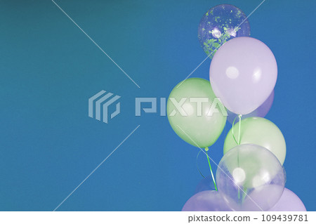 Balloons of light colors - white, light green, transparent on a blue background. Balloons of light colors - white, light green, transparent on a blue background. 109439781