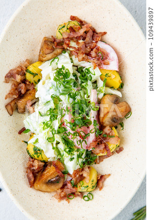 salad with potatoes, rice, meat and green onions side view 109439897