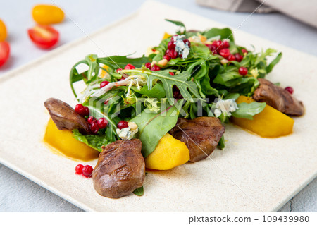 meat medallions with arugula, peach slices and red berries, side view meat medallions with arugula, peach slices and red berries, side view 109439980