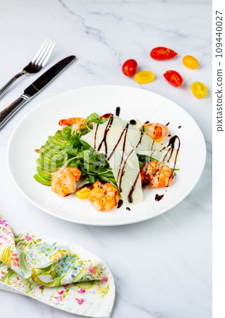 shrimp with avocado slices and arugula with teriyaki sauce side view shrimp with avocado slices and arugula with teriyaki sauce side view 109440027