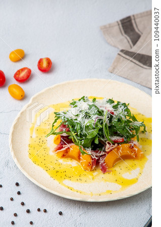 green salad with arugula and lingonberries on a white plate and marble background top view green salad with arugula and lingonberries on a white plate and marble background top view 109440037