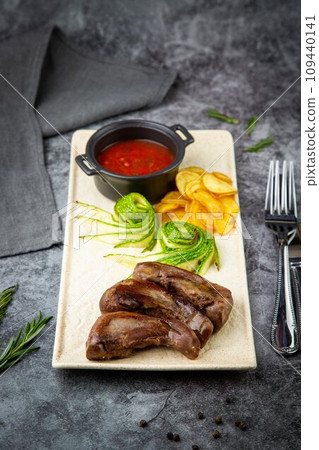 lamb tongues with mashed potatoes and tomato sauce side view lamb tongues with mashed potatoes and tomato sauce side view 109440141