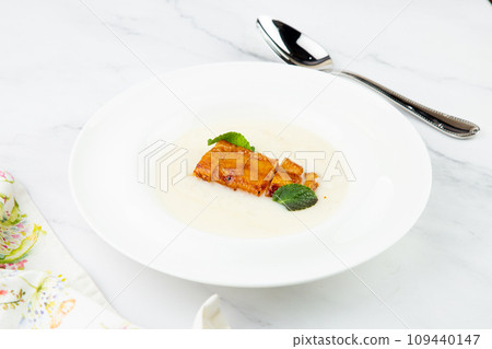 side view of porridge with mint leaves and pieces of meat in sweet and sour sauce side view of porridge with mint leaves and pieces of meat in sweet and sour sauce 109440147