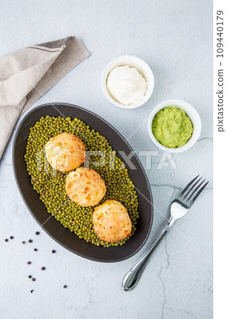 corn baursaks with kaymak sauce in a plate with cereal side view corn baursaks with kaymak sauce in a plate with cereal side view 109440179