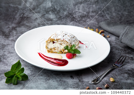sweet sponge dessert with raspberries and powdered sugar side view sweet sponge dessert with raspberries and powdered sugar side view 109440372