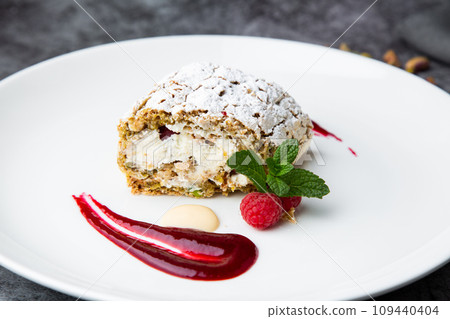 sweet sponge dessert with raspberries and powdered sugar side view 109440404