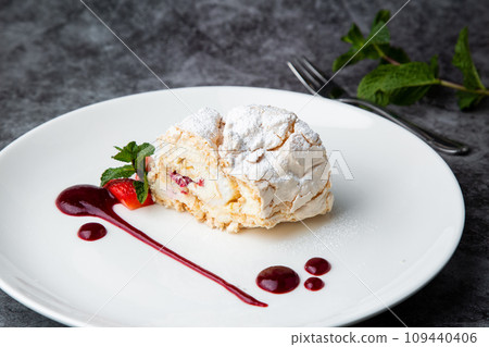 sweet sponge dessert with raspberries and powdered sugar side view 109440406