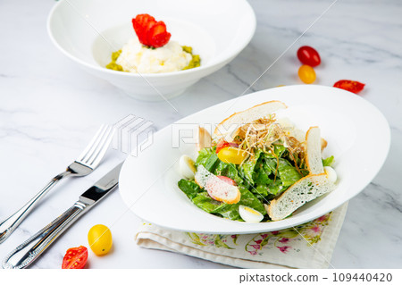 salad with quail eggs, cherry tomatoes, lettuce and breadcrumbs, side view 109440420