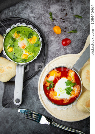 borscht in a frying pan with fresh flatbreads and cherry tomatoes top view 109440464