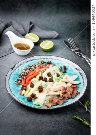 different types of meat, sesame seeds, greens and croutons, side view 109440524