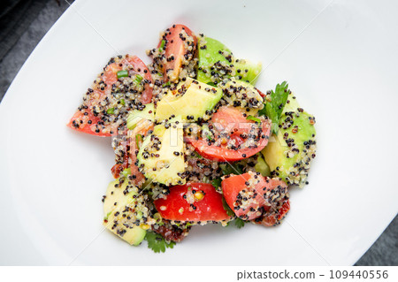 salad of tomatoes, zucchini, grated garlic with a lot of sesame seeds, top view salad of tomatoes, zucchini, grated garlic with a lot of sesame seeds, top view 109440556