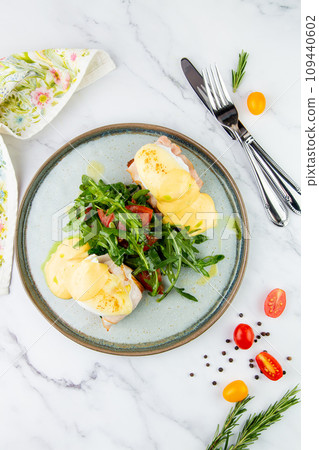 breakfast of arugula and tomato, toast with cheese and poached egg, top view breakfast of arugula and tomato, toast with cheese and poached egg, top view 109440602