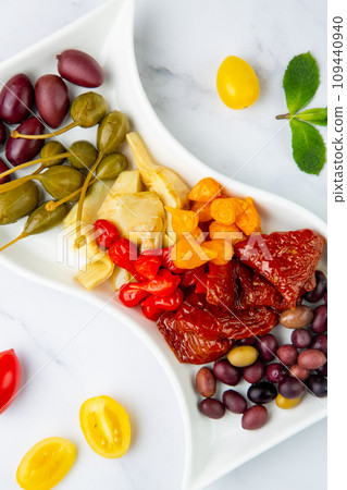 assorted nuts and dried vegetables on a light background side view assorted nuts and dried vegetables on a light background side view 109440940