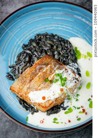 black beans with big fish steak, green onions and cream sauce, top view black beans with big fish steak, green onions and cream sauce, top view 109440965