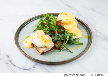 breakfast of arugula and tomato, toast with cheese and poached egg, top view breakfast of arugula and tomato, toast with cheese and poached egg, top view 109440966