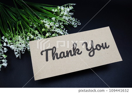 Thank you text message with flower decoration on black background Thank you text message with flower decoration on black background 109441632