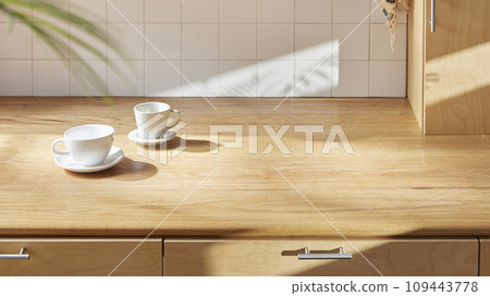 A sunny kitchen with white tile walls, a wooden table and sink. 109443778