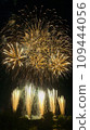 Fireworks that draw a beautiful parabola with the orange color of the fireworks display 109444056