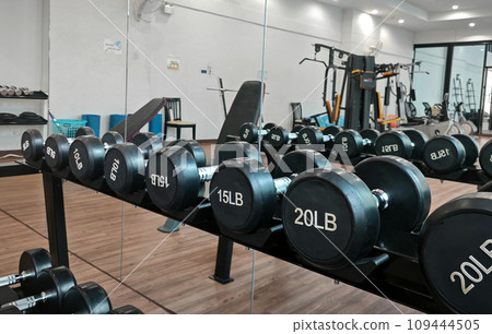 Dumbbell at fitness Gym to build muscle ,Sports equipment in gym. Dumbbell at fitness Gym to build muscle ,Sports equipment in gym. 109444505