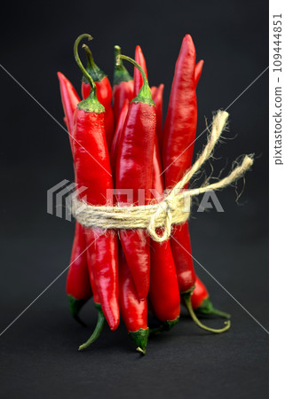Chili pepper isolated on a black background. Knitted hot chili pepper tied with a rope. Chili hot pepper clipping path 109444851