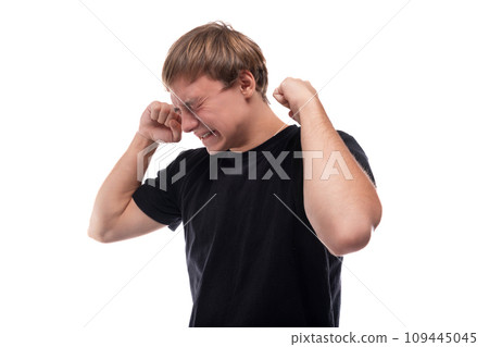 Caucasian guy with blond hair is upset and almost crying Caucasian guy with blond hair is upset and almost crying 109445045