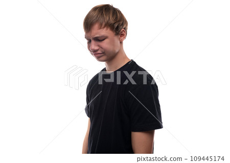 Puzzled European teenage boy with blond hair on white background 109445174