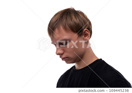 Handsome Caucasian blond teenager guy in a black T-shirt is upset because of problems 109445236