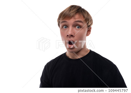 Portrait of a surprised teenage guy with blond hair on a white background 109445797