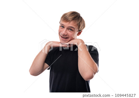 Portrait of a cute teenage guy with blond hair on a white background 109445827