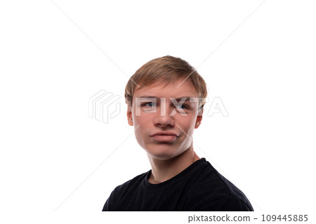 European blond teenager boy wearing a black T-shirt is proud of himself 109445885
