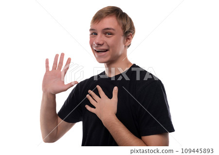 Portrait of a positive smiling blond teenager guy in a black T-shirt 109445893