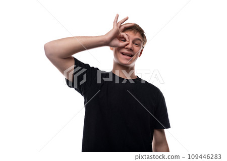 Portrait of a cheerful blond teenager guy with a grimace Portrait of a cheerful blond teenager guy with a grimace 109446283