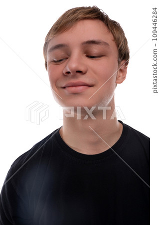 Close-up portrait of a blond 16 year old teenage boy against a background with copy space 109446284