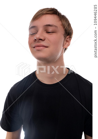 Cute fair-haired teenager guy on a white background, close-up portrait 109446285