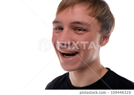 Close-up portrait of a blond teenager young man with kind eyes Close-up portrait of a blond teenager young man with kind eyes 109446328