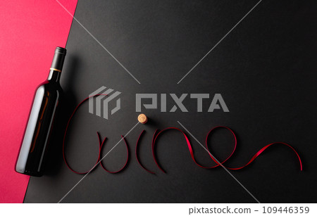Bottle of red wine with red satin ribbons. Bottle of red wine with red satin ribbons. 109446359