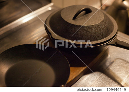 small iron frying pan and skillet lid 109446549