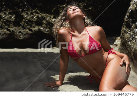 Happy Beautiful body woman in bikini on sand near the stones 109446779
